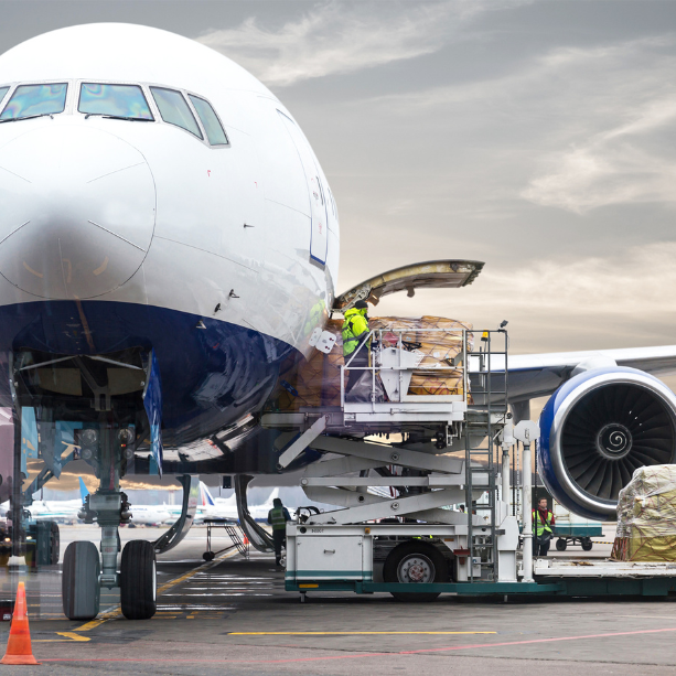 An aeroplane being loaded with packages.