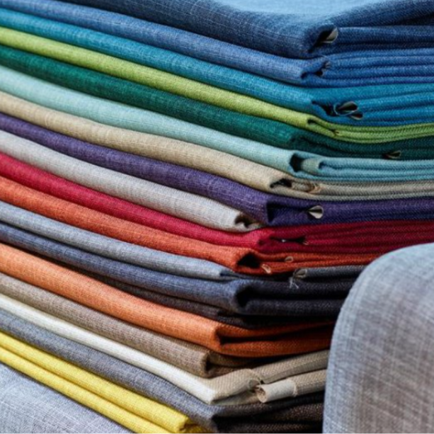 A pile of folded fabrics.