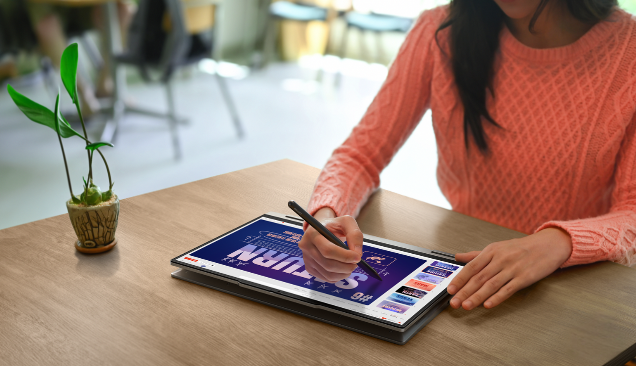 Close up of woman using a Lenovo tablet with a stylus.