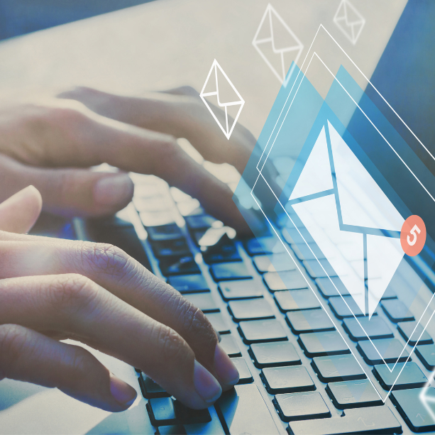 Hands typing on a keyboard up close and overlays of emails.