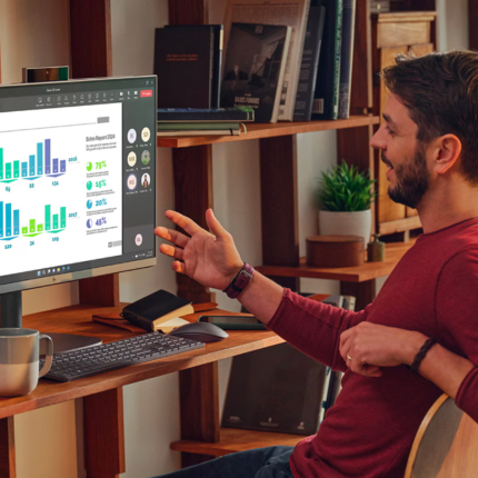 A man is reclining in his office chair as he speak to the person on the video call on his PC.