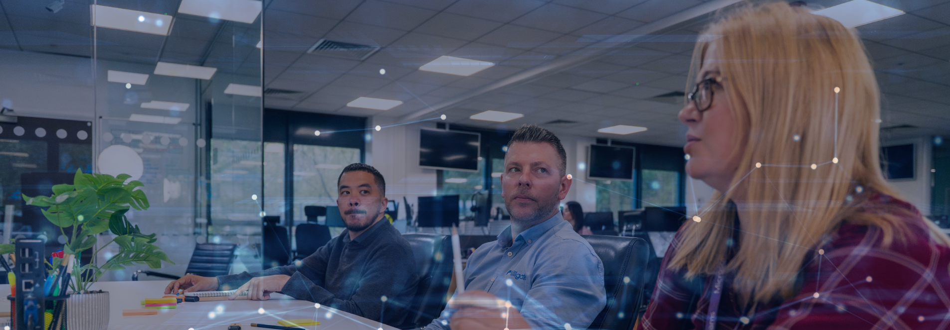 Group image of of three Millgate team members at a table discussing Cyber Security in Sheffield