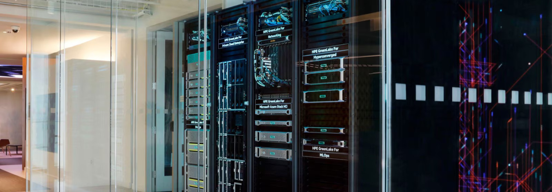 A long shot of a server room in an office, glass walls surround it.