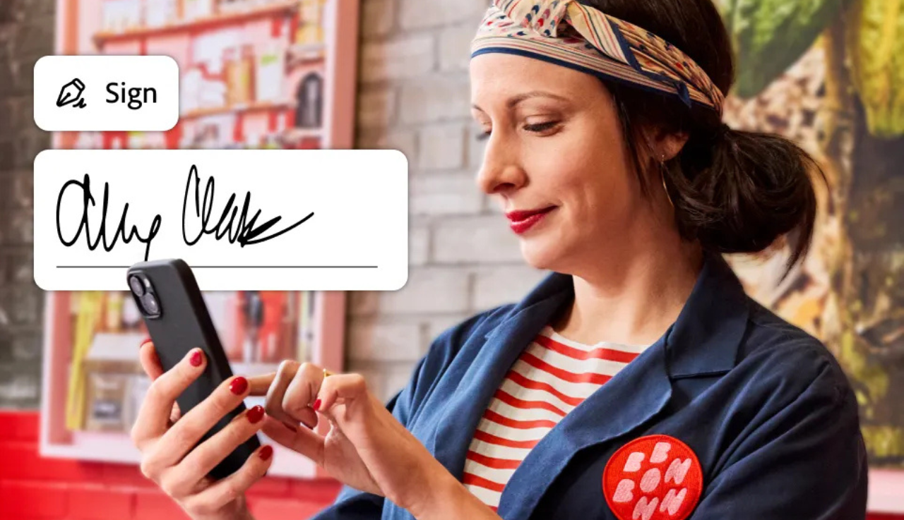 A woman using her phone overlayed by a signature field.