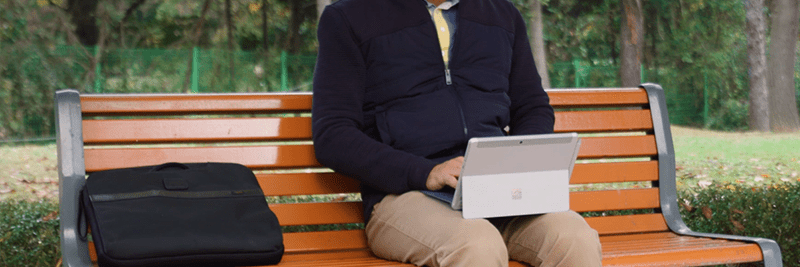 man sat on bench with labtop